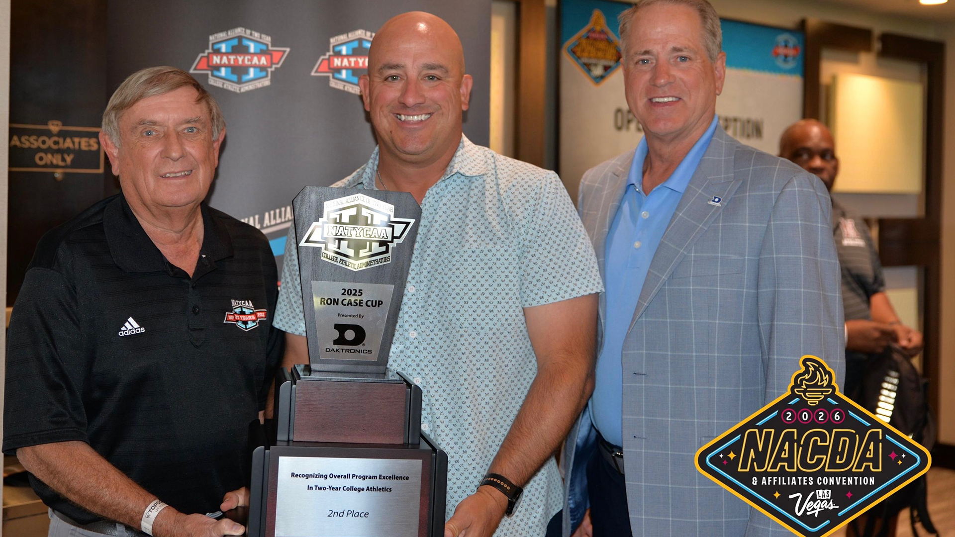 Joliet JC Director of Athletics Gregg Braun is presented with the second place trophy for the Ron Case Cup presented by Daktronics.